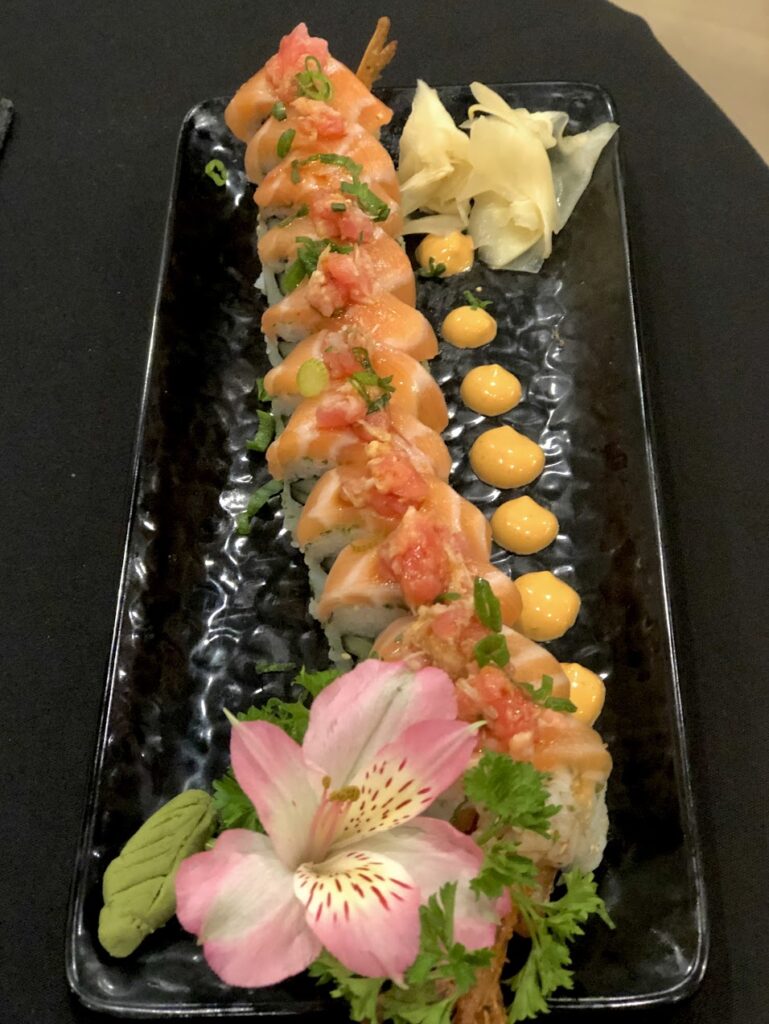 Sushi roll on a plate with a flower.